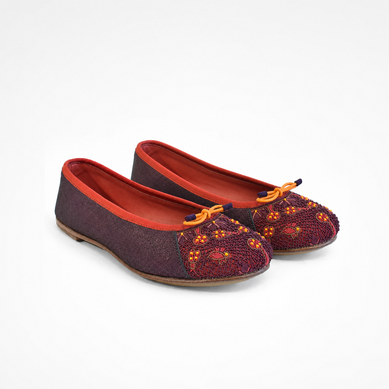 Pair of Eden Ballet flats in beige and black leather with embroidered toe panels and bow detai