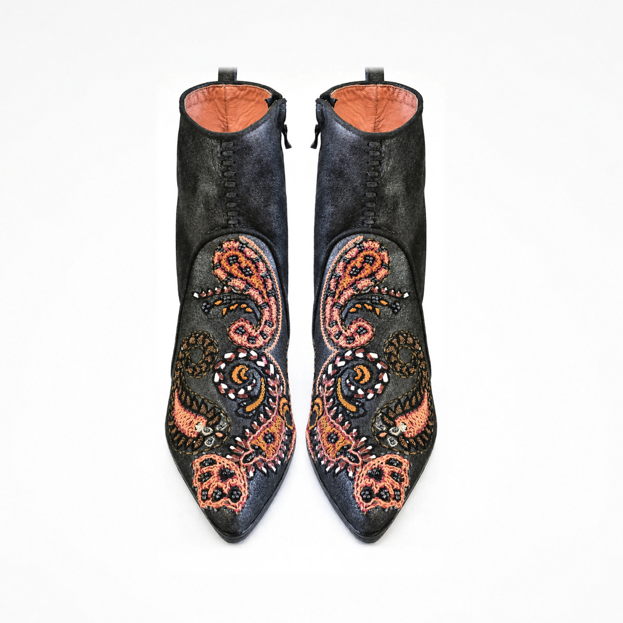 Front view of shiny black leather Phyllis Point heeled boots showing pointed toes and multicolour paisley embroidery