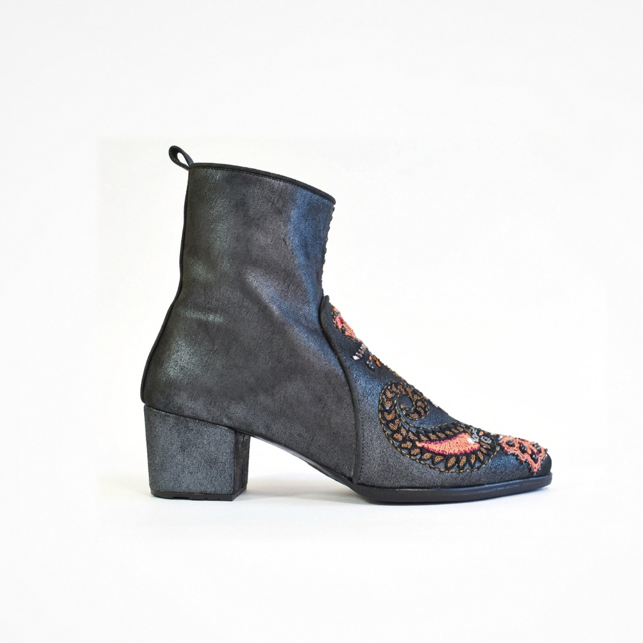 Side view of a shiny black leather Phyllis Point heeled boot with a block heel, embroidered front panel and pull tab