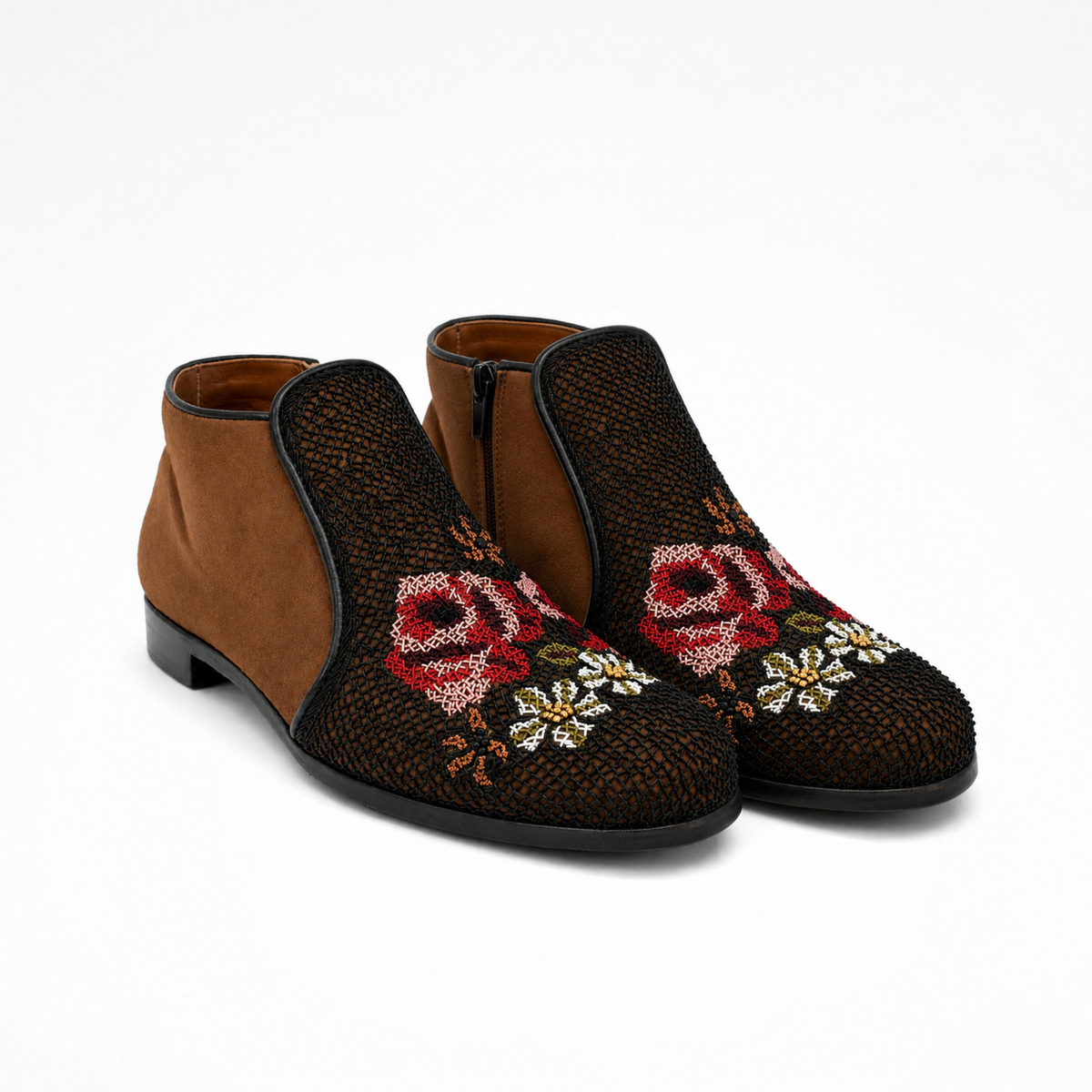 Pair of Queen Nora ankle boots in toffee brown suede with black embroidered fronts, floral motifs, rounded toes and side zips
