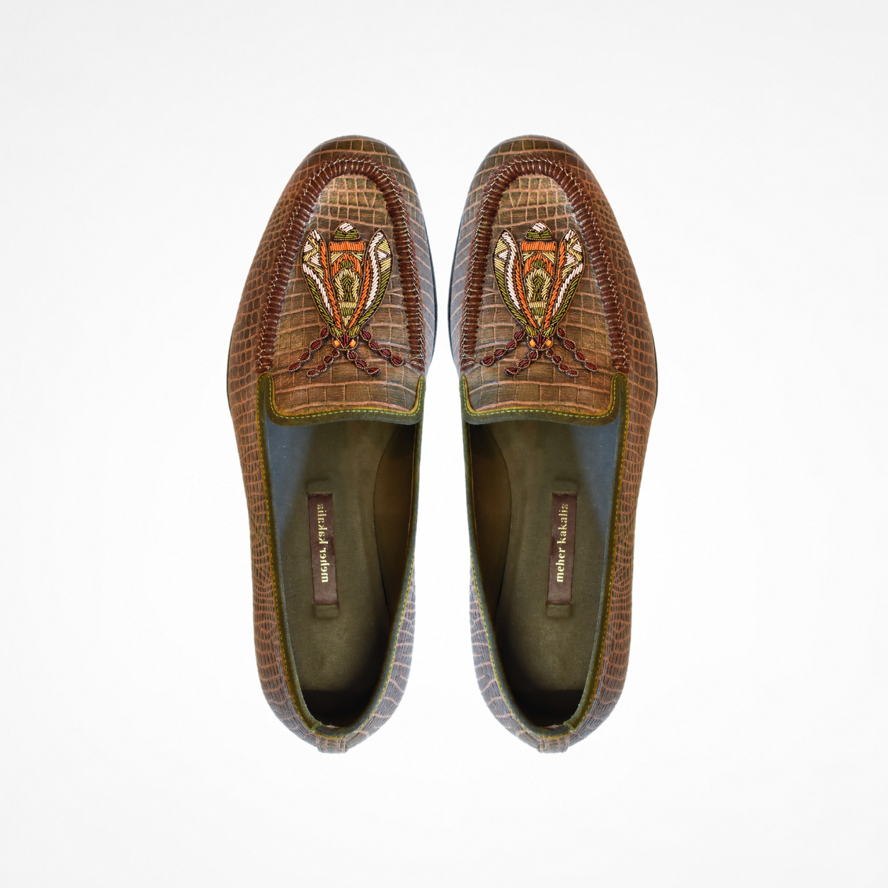 Pair of textured camouflage loafers showing orange, cream and olive insect embroidery