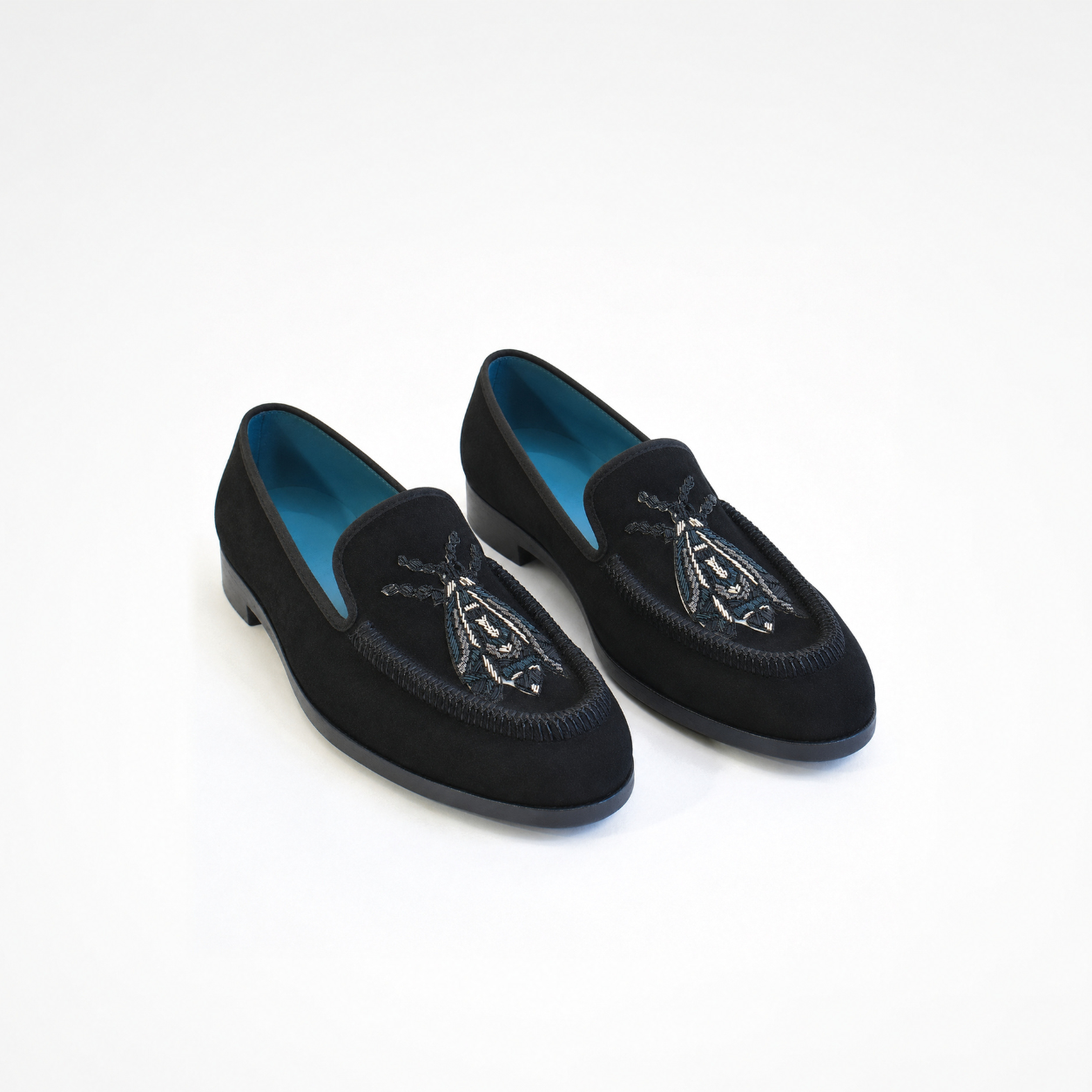Pair of Rati Loafers in black suede with blue and white embroidered insect motifs