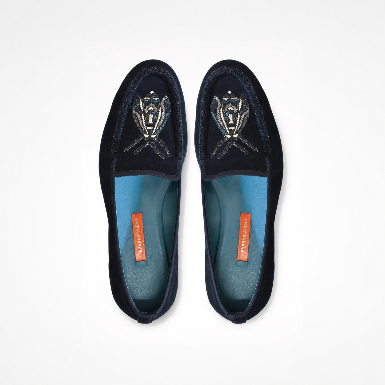 Pair of black suede loafers showing blue and white insect embroidery and rounded toes