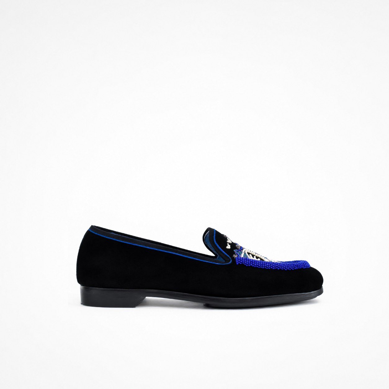 Black suede loafer with low heel, blue piping and embellished vamp