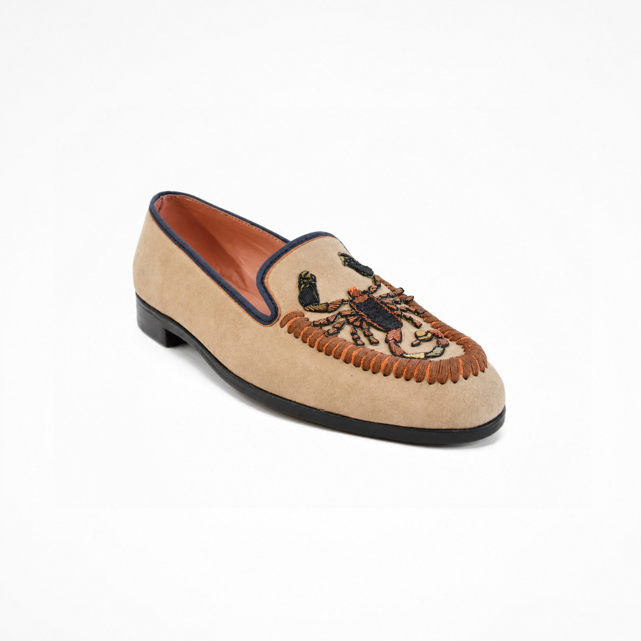 Beige suede loafer with scorpion-inspired embroidery, rounded toe and low heel