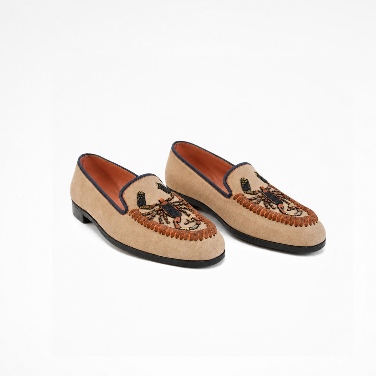 Pair of Scorpio Loafers in beige suede with embroidered scorpion motifs and dark piping