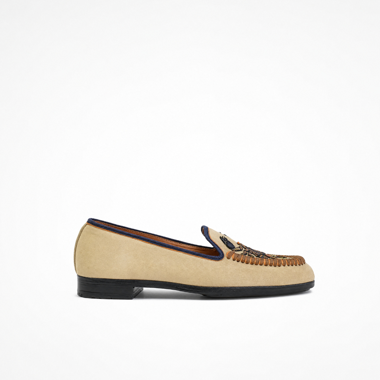 Beige suede slip-on loafer with low heel, embroidered vamp and contrasting dark trim