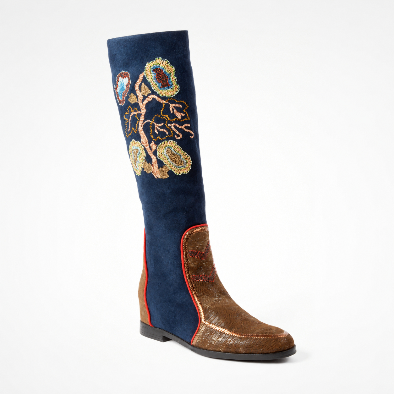 Angled view of the TONYA navy suede boot with botanical hand embroidery and a brown textured leather lower panel