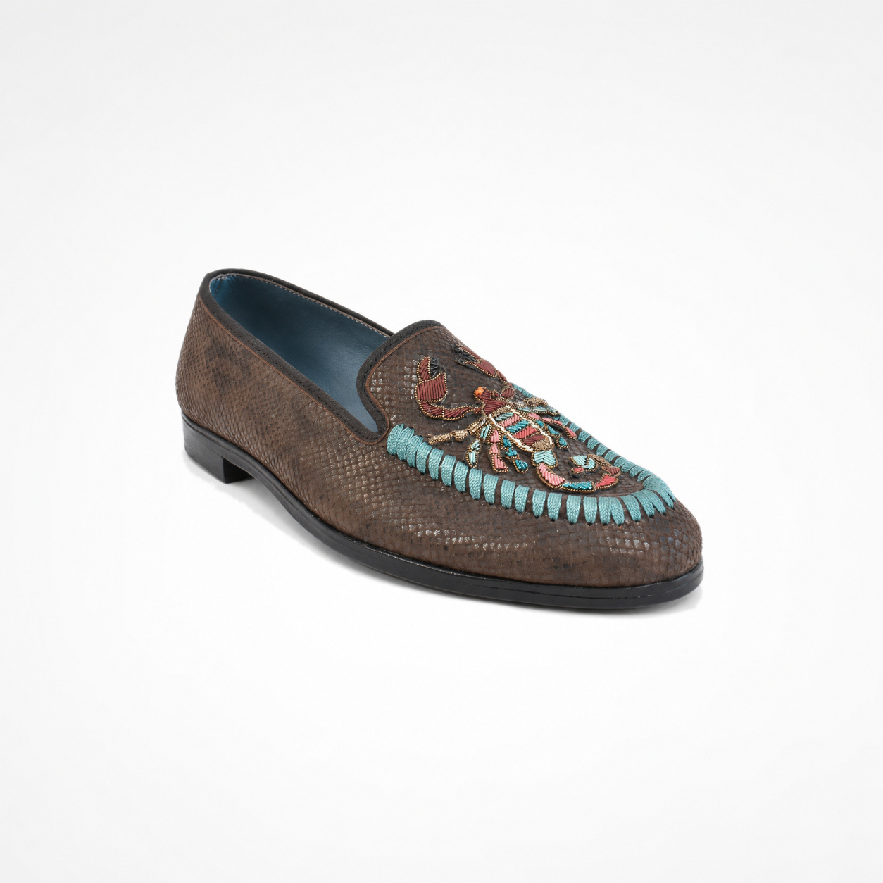 Textured brown loafer with multicolour scorpion-inspired embroidery and turquoise cord detail