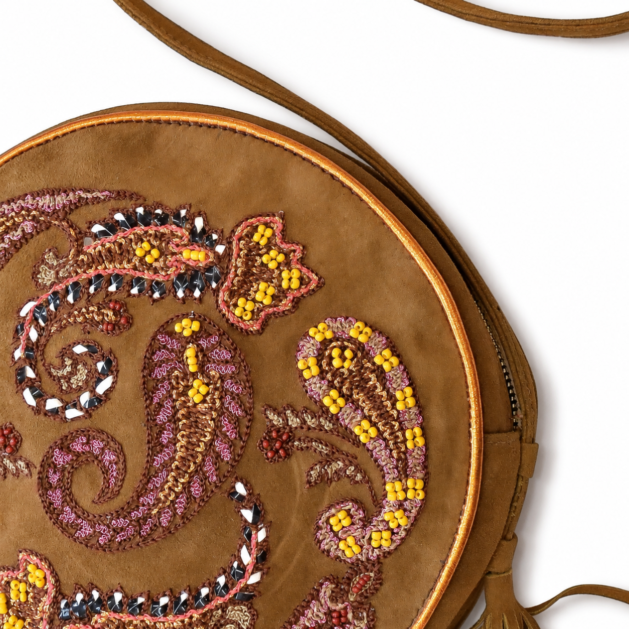 Close-up of suede spice round bag showing paisley embroidery, yellow beadwork and metallic details