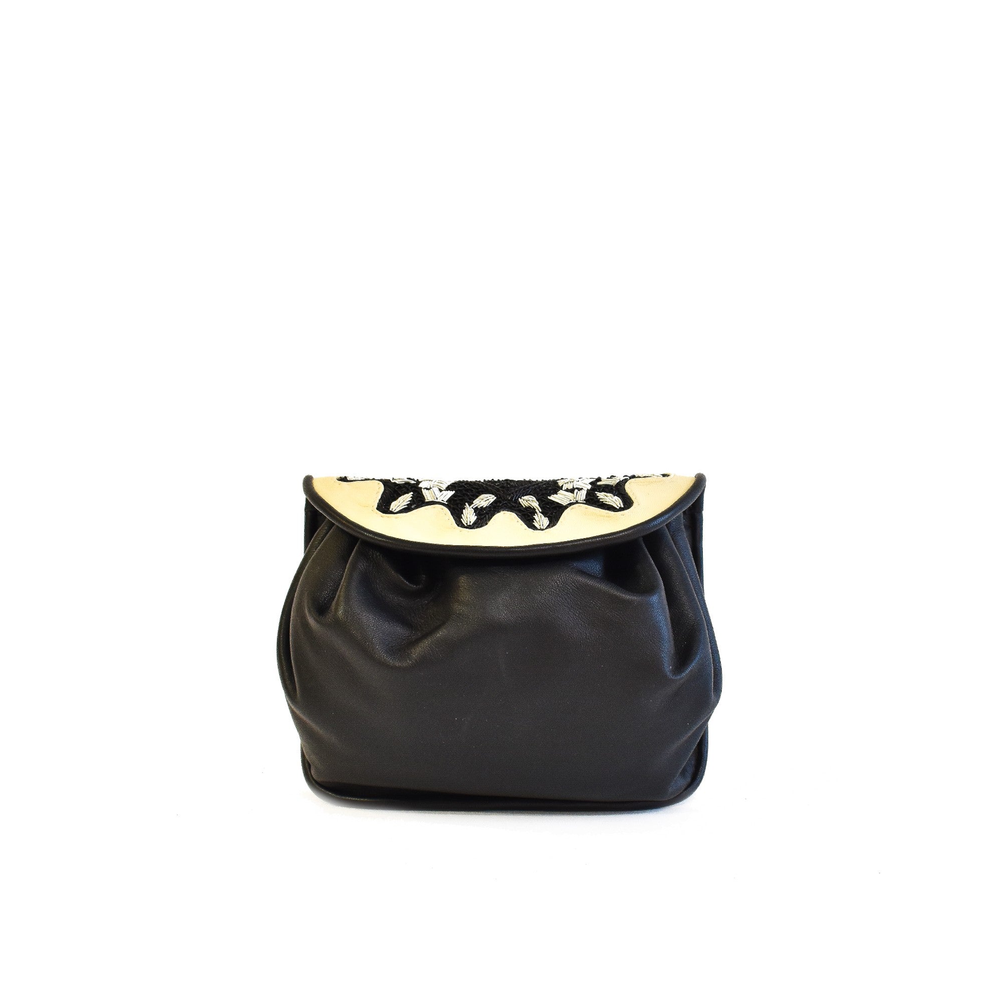 Small accordion-style leather bag in black and white with detachable strap.