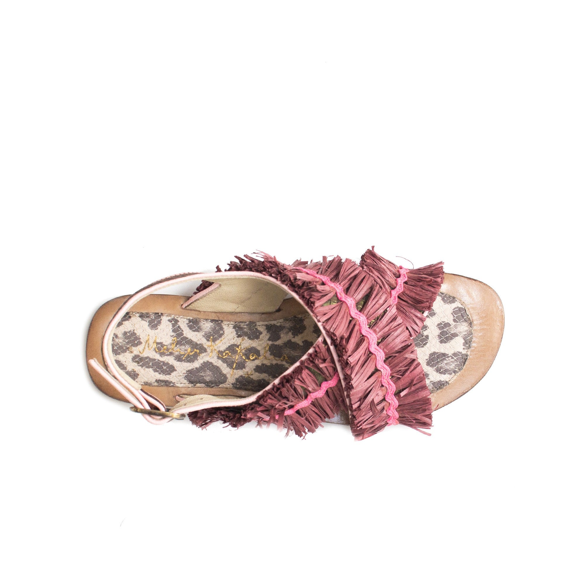 Top-down view of handcrafted summer sandal with bold colour and animal print details.