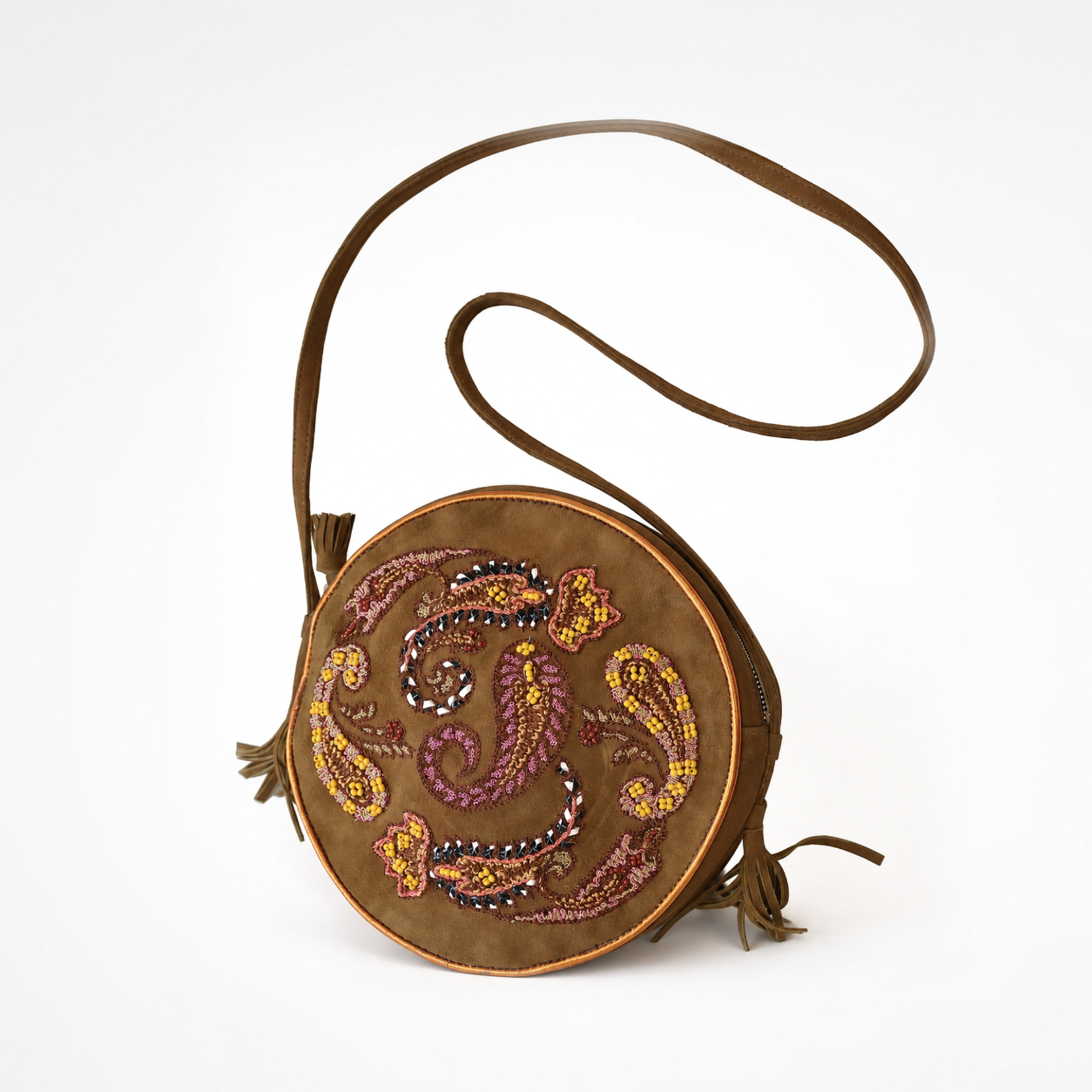 Suede spice round crossbody bag with embroidered paisley motifs, long shoulder strap and tassel details