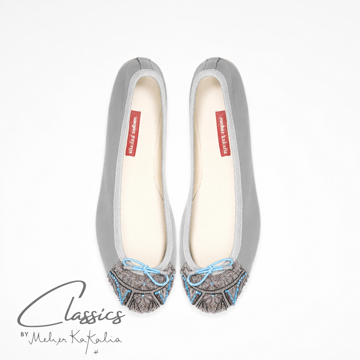 Pair of grey leather BIZI ballet flats with hand-embroidered toe caps, top view