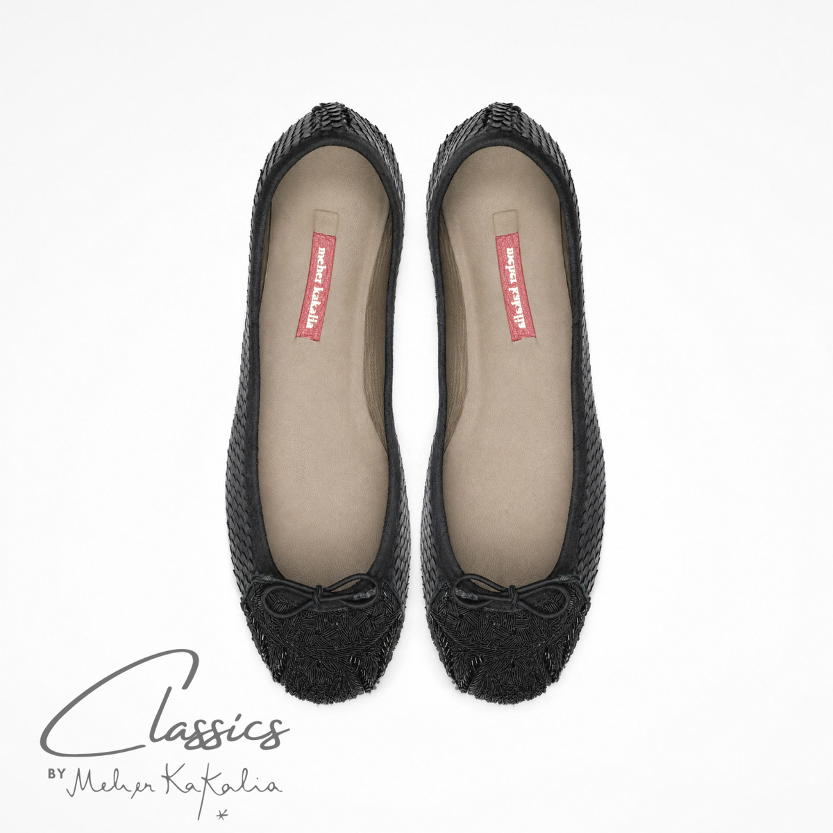 Pair of black leather BIZI ballet flats with hand-embroidered toe caps, top view